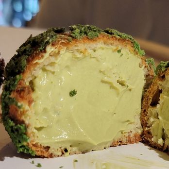 Bibble & Sip - Cross section of the matcha white chocolate cream puff - Coffee & Tea Near Me - New York, New York Bibble & Sip - Cross section of the matcha white chocolate cream puff - Coffee & Tea Near Me - New York, New York