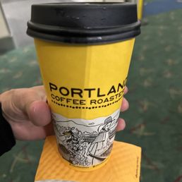 a hand holding a cup of coffee