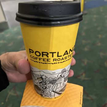 Portland Coffee Roasters - a hand holding a cup of coffee - Coffee & Tea Near Me - Portland, Oregon