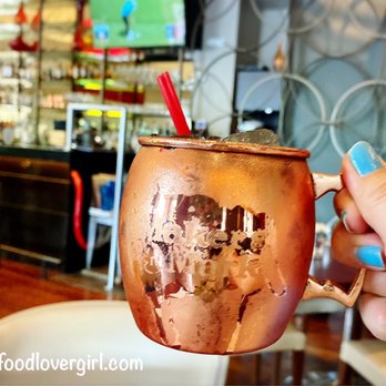 Uproot - a hand holding a moscow mule - New American Near Me - Warren, New Jersey