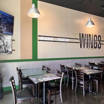 Wingstop - tables and chairs in a restaurant - Chicken Wings Near Me - Huntsville, Alabama Wingstop - tables and chairs in a restaurant - Chicken Wings Near Me - Huntsville, Alabama
