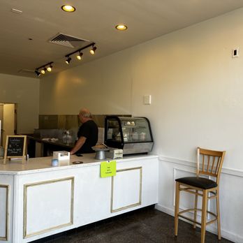 Cupcakesters - a man standing at a counter in a bakery - Desserts Near Me - Gilbert, Arizona