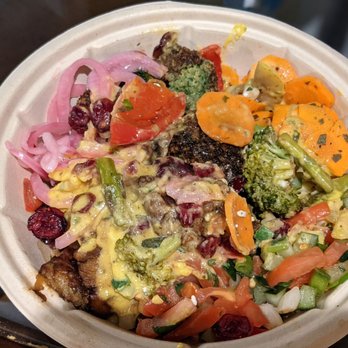 mezeh - Falafel over cauliflower rice w/Turkish salad, spicy hummus, picked onions, caramelized eggplant, roasted vegetables, & carrots - Mediterranean Near Me - Charlottesville, Virginia