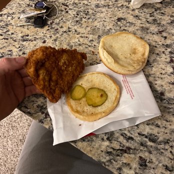 Chick-fil-A - ows a hand holding a piece of fried chicken and a sandwich - Fast Food Near Me - Arvada, Colorado Chick-fil-A - ows a hand holding a piece of fried chicken and a sandwich - Fast Food Near Me - Arvada, Colorado