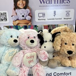 Greenville Floral & Gifts - These plush Warmies come in teddy bears, unicorns, dinosaurs, dogs, cats, and other cuddly animals.
