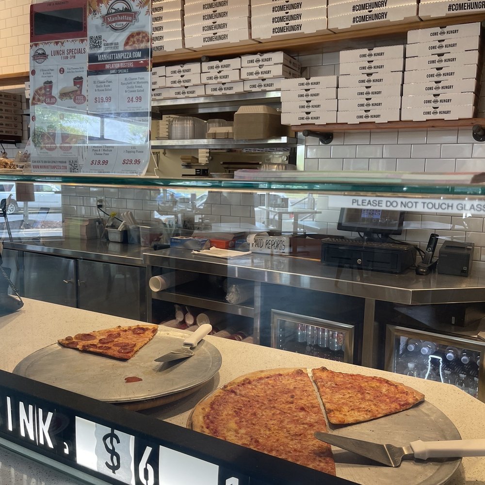 Manhattan Pizza - two slices of pizza on a counter - Pizza Near Me - Frederick, Maryland
