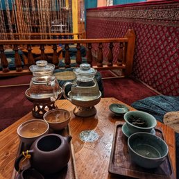 a variety of tea cups on a table a variety of tea cups on a table