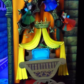 Sleeping Beauty Castle Walkthrough - Fauna, Merryweather and Flora - The Three Good Fairies about to bless baby Princess Aurora. - Amusement Parks Near Me - Anaheim, California Sleeping Beauty Castle Walkthrough - Fauna, Merryweather and Flora - The Three Good Fairies about to bless baby Princess Aurora. - Amusement Parks Near Me - Anaheim, California