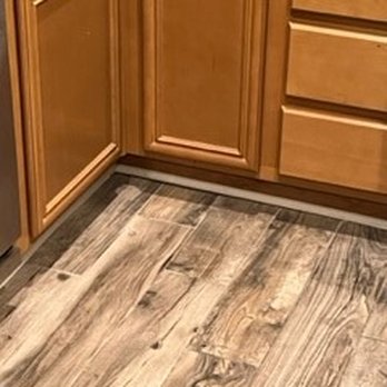 World Flooring - Destroyed under cabinet trim, replaced with white quarter round. - Flooring Near Me - El Cajon , California