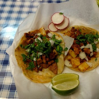 Aqui Es - Two tacos al pastor with onions and cilantro with a side of lime and radish. - Mexican Near Me - Bethlehem, Pennsylvania