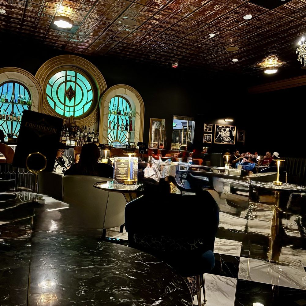 John Wick Experience - Waiting lounge bar. Gorgeous attention to detail and fun photos of old Vegas on the wall. - Escape Games Near Me - Las Vegas, Nevada John Wick Experience - Waiting lounge bar. Gorgeous attention to detail and fun photos of old Vegas on the wall. - Escape Games Near Me - Las Vegas, Nevada