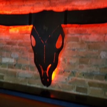 BBG’s - a bull skull on a brick wall - Sports Bars Near Me - Austin, Texas