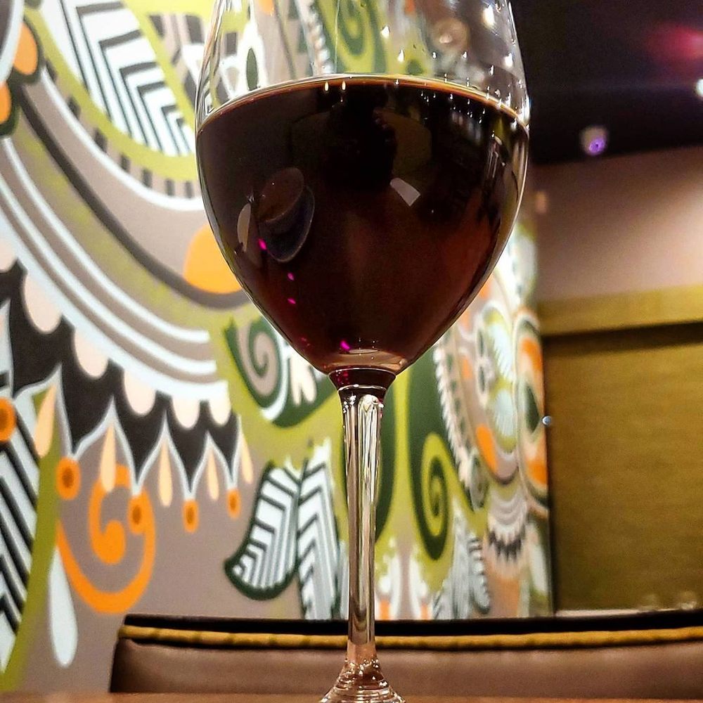 Anokha - a glass of wine on a table - Indian Near Me - Richmond, Virginia Anokha - a glass of wine on a table - Indian Near Me - Richmond, Virginia