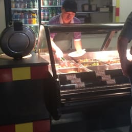 a man standing in front of a buffet a man standing in front of a buffet