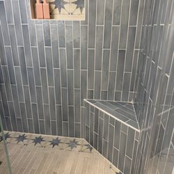 Blue subway tile with accent tile in shower.