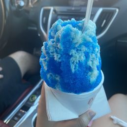 Small blue coconut with sweet cream on top.