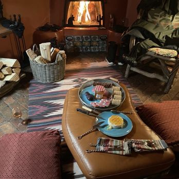 Adobe and Pines Inn - relaxing in front of the fireplace after a day of snowboarding - Bed & Breakfast Near Me - Taos, New Mexico