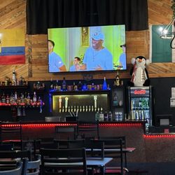 La Choza Latin Cuisine - Big screen over the bar with videos of the band playing the music