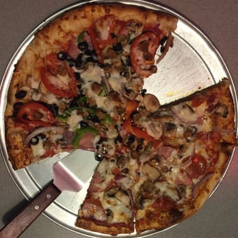 Capone's Pizza - The Untouchable speciality pizza minus some toppings on half. We were too hungry to take the picture before the first slice! - Pizza Near Me - Riverside, California