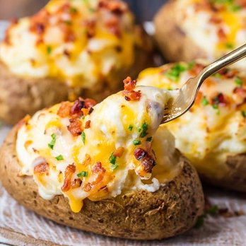 Rouge Canopy Catering - a close up of a potato with cheese and bacon - Caterers Near Me Rouge Canopy Catering - a close up of a potato with cheese and bacon - Caterers Near Me
