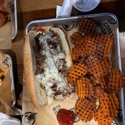 East Coast Wings + Grill - Steak philly with sweet potato fries