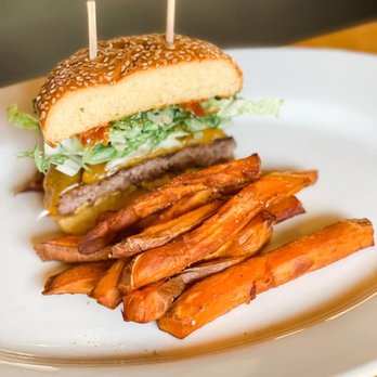 Doc B's Restaurant + Bar - Half of a Traditional Cheeseburger and sweet potato fries - New American Near Me - Fort Worth, Texas