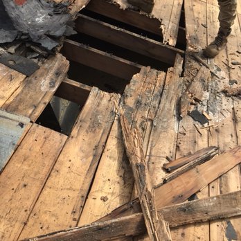 Gemini Home Improvement - a man standing on a wooden deck with a hole in the floor - General Contractors Near Me - Seekonk, Massachusetts Gemini Home Improvement - a man standing on a wooden deck with a hole in the floor - General Contractors Near Me - Seekonk, Massachusetts
