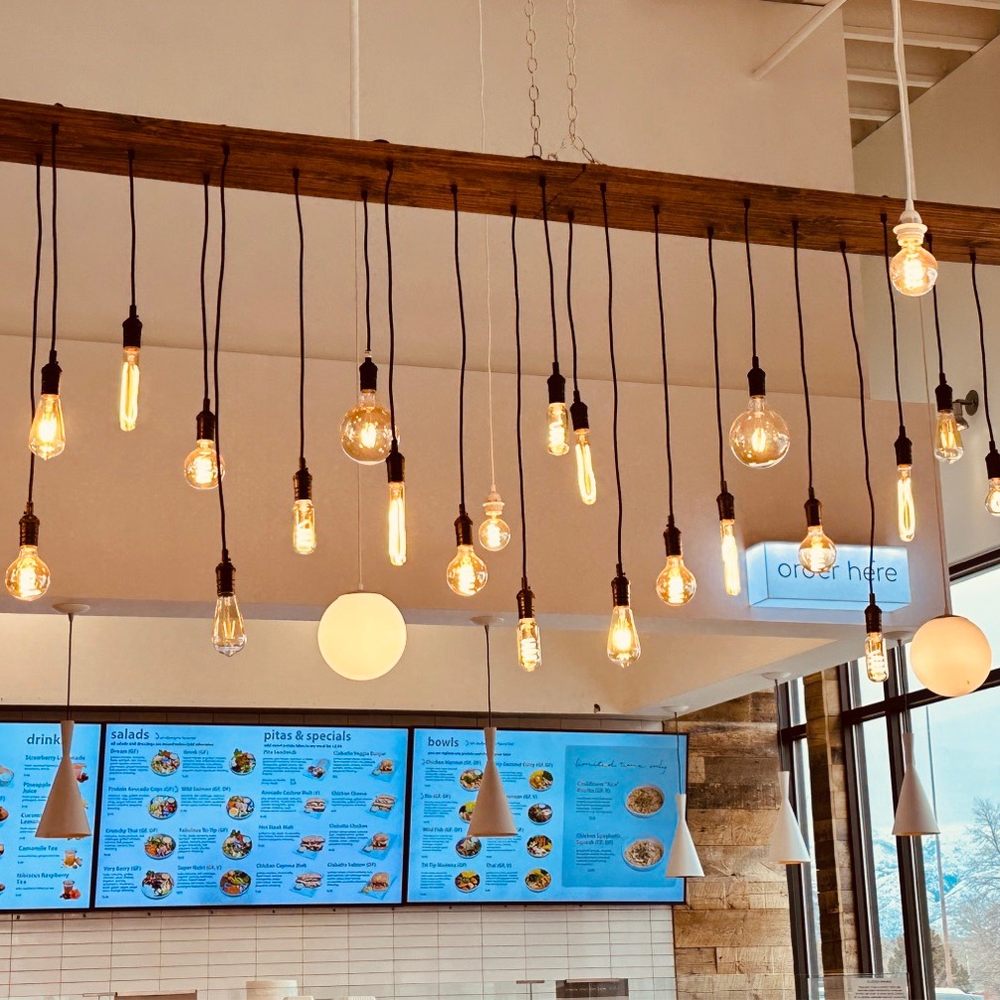 Aubergine Kitchen - a kitchen with a large window and lots of light bulbs hanging from the ceiling - Mediterranean Near Me - American Fork, Utah