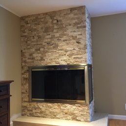 New split face travertine on the vertical, with travertine 12x24 on the hearth.  All edges were miter-cut or rounded.