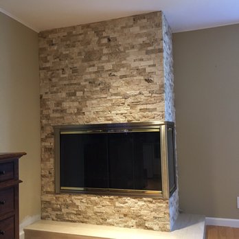 Alex's Custom Tile - New split face travertine on the vertical, with travertine 12x24 on the hearth.  All edges were miter-cut or rounded. - General Contractors Near Me
