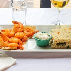 Old City Cafe & Grill - A flavorful seafood entrée served with rice, fresh greens, and a creamy dipping sauce.