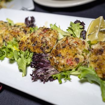 Butterfields - a plate of crab cakes on a bed of lettuce - New American Near Me - Hauppauge, New York Butterfields - a plate of crab cakes on a bed of lettuce - New American Near Me - Hauppauge, New York