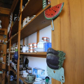 Leo's Cafe - a wooden shelf with various items on it - American Near Me - Annapolis Royal, Nova Scotia Leo's Cafe - a wooden shelf with various items on it - American Near Me - Annapolis Royal, Nova Scotia