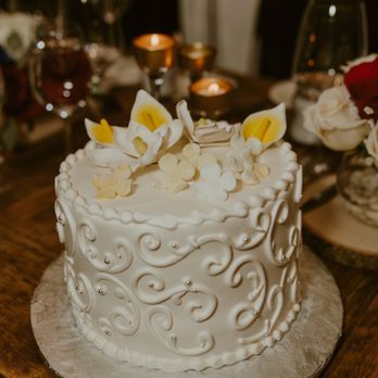 Diamond Bakery - a white wedding cake on a wooden table - Bakeries Near Me - Monterey Park, California