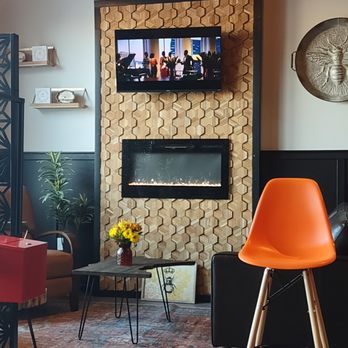 The Rusty Bumblebee - Sitting area w honeycomb wall w tv & fireplace & MN table out front - Beer Bar Near Me - Blaine, Minnesota