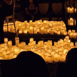 Hundreds if not thousands of flameless white pillar candles Hundreds if not thousands of flameless white pillar candles
