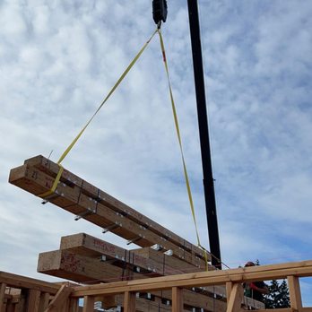 Rainier Contracting Services - Installing joist hangers on beams before they come up - General Contractors Near Me Rainier Contracting Services - Installing joist hangers on beams before they come up - General Contractors Near Me