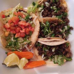 Serrano's taqueria - Fish taco on the left...Daily special of 3 carne steak tacos on the right.