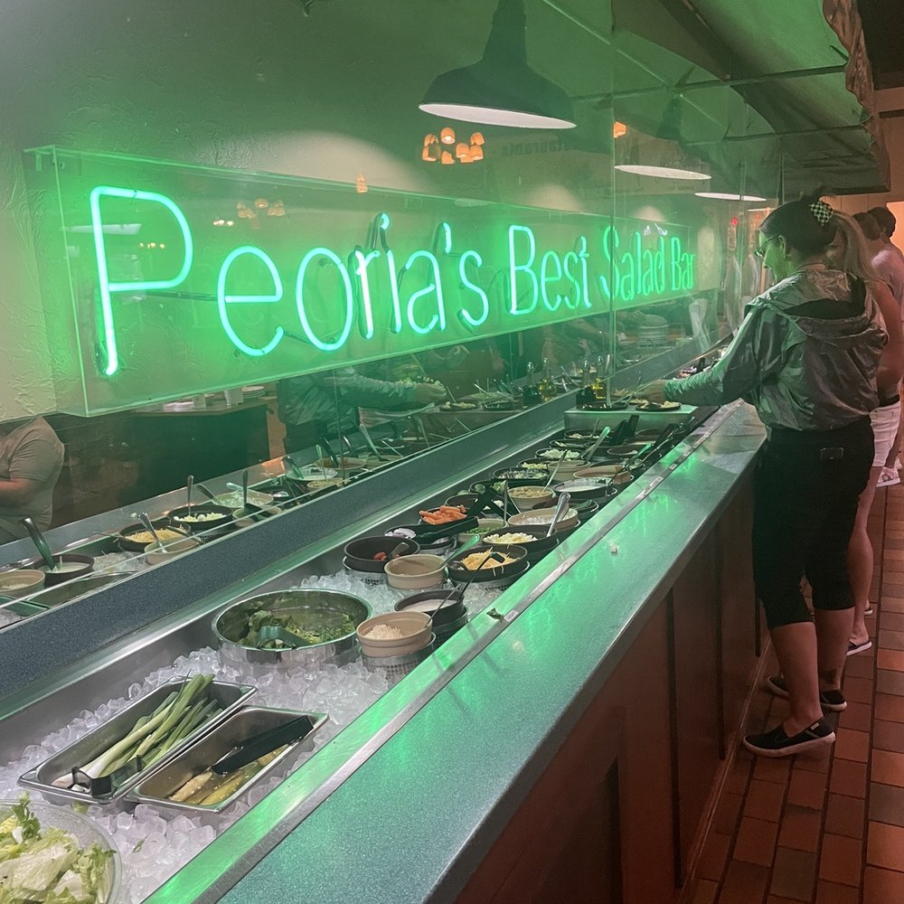 Alexander's Steakhouse - a woman standing in front of the counter - Steakhouses Near Me - Peoria, Illinois