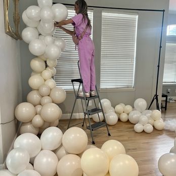 Cloud 9 Collective - Set up for a white linen party photo backdrop.  A fun way for your guests to capture unforgettable moments! - Balloon Services Near Me