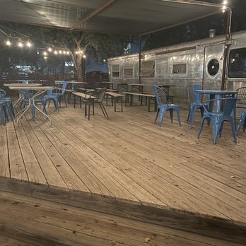 Burleson Yard Beer Garden - More outdoor seating.  Not sure what the silver bullet camper is for if anything. - New American Near Me - San Antonio, Texas
