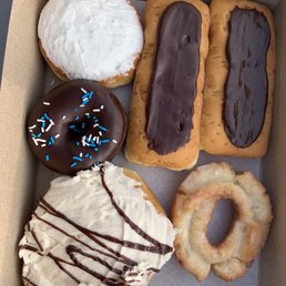 Two custard long johns, old fashioned glazed donut, peanut butter cinnamon roll, cherry filled, and chocolate case Two custard long johns, old fashioned glazed donut, peanut butter cinnamon roll, cherry filled, and chocolate case