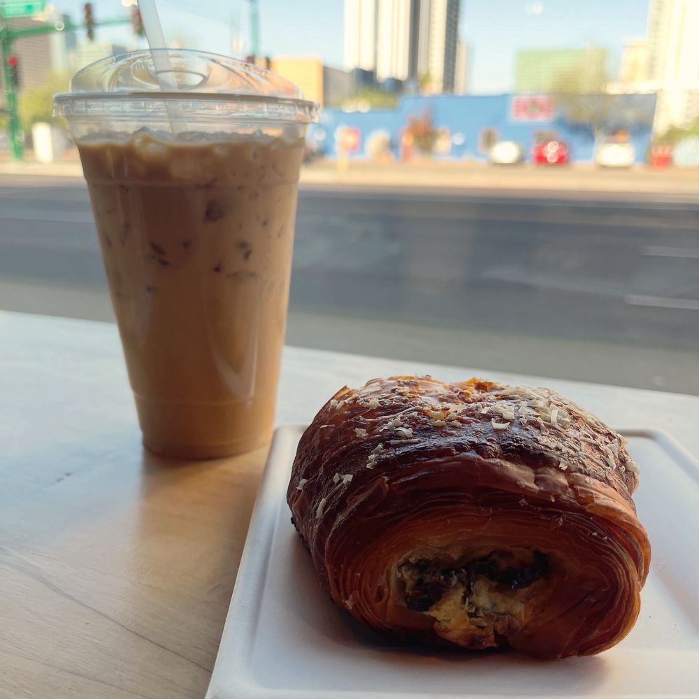 Oatmilk latte and spinach artichoke croissant