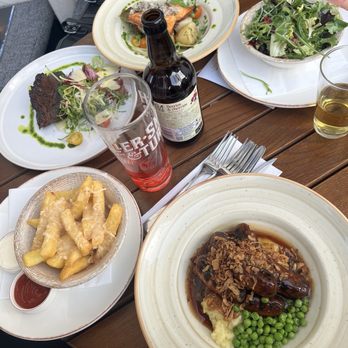 The Victoria - Bottom to top: Cumberland sausages, truffle cheese fries, Bavette steak, pan roasted salmon, side spring leaf salad - Pubs Near Me - Paddington, XGL The Victoria - Bottom to top: Cumberland sausages, truffle cheese fries, Bavette steak, pan roasted salmon, side spring leaf salad - Pubs Near Me - Paddington, XGL