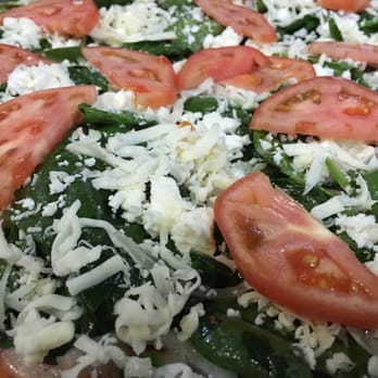 Pizza Way - a pizza topped with tomatoes and cheese - Pizza Near Me - Montreal, Quebec