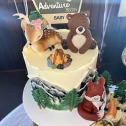 Pastry and More - Beautiful cake for a gender reveal. Notice the deer has one horn and flowers to represent either boy or girl. So well done!