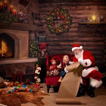 TS Gallant Photography - Photo of Santa and two children looking at the naughty list while eating cookies in a log cabin living room in Billings Montana - Session Photography Near Me - Laurel, Montana TS Gallant Photography - Photo of Santa and two children looking at the naughty list while eating cookies in a log cabin living room in Billings Montana - Session Photography Near Me - Laurel, Montana