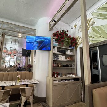FL Cafe - Interior with sharks on the screen . - New American Near Me - Miami Beach, Florida FL Cafe - Interior with sharks on the screen . - New American Near Me - Miami Beach, Florida