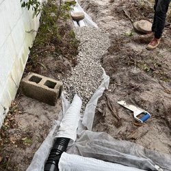 Beachside Luxury Landscaping - French drain installed around house.