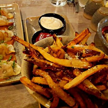 Moku Kitchen - Garlic truffle oil fries, $8 and pork pot stickers for $10 - Cocktail Bars Near Me - Honolulu, Hawaii